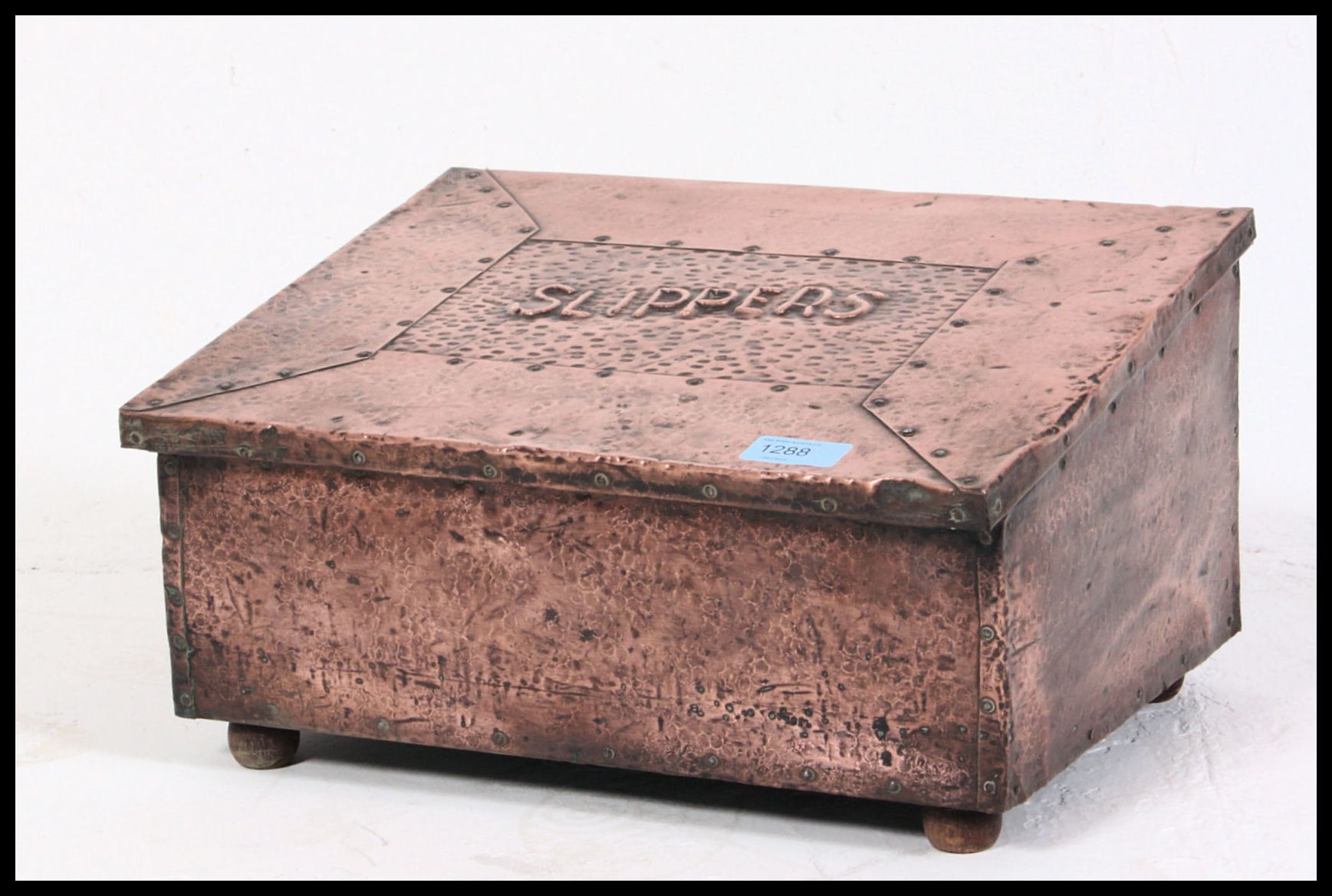 A hand beaten scratch built early Edwardian copper slipper box along with an oak arts and crafts