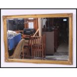 An early 20th century over mantle gilt framed wall mirror having foliate molding's to the frame.