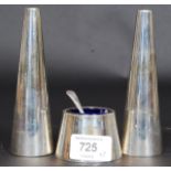 A contemporary silver plated condiments - salt and pepper pots together with a blue glass lined