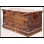 A Victorian scrumble finished pine blanket box chest with hinged top and plinth base.