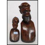 A 20th century African tribal bust of polished carved mahogany.