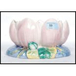 A Clarice Cliff bowl formed as a water lily decorated in pastel shades with pink leaves and blue