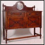 A 1930's golden oak mirror back barleytwist sideboard.