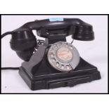 A vintage mid 20th century GPO bakelite telephone having a recent conversion with contacts drawer