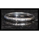 A 20th century Platinum band ring of plain simple form with banded chase decoration. Total weight 3.