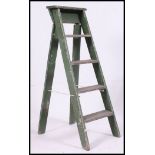 A painted mid century shabby chic Industrial step ladder in original green paint finish.
