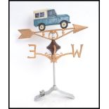 A 20th century weathervane and mount, with Land Rover painted figure to top.