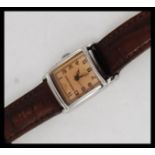 An Emporio Armani ladies dress watch with square face, caramel dial set to a leather strap.