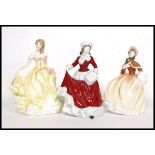 A collection of 3x Royal Doulton china ' Pretty Ladies ' figurines all being stamped to the base;
