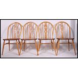 A set of four contemporary light elm seat and beech wheelback chairs,