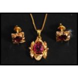 A 22ct gold and ruby pendant necklace set to an 18ct gold chain.