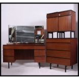 An excellent 1970's Meredew teak wood retro bedroom suite consisting of a pair of bedside cabinets,