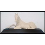 A good quality Beswick ceramic white horse figurine raised on a plinth.