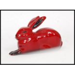 A Royal Doulton Flambe figure of a seated hare, bold black and red colouring,