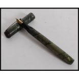 A vintage 20th century Mentmore Supremen Lever Fill Fountain Pen  having snakeskin effect cap and