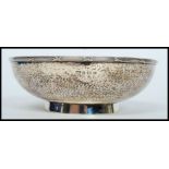 A silver hallmarked hand beaten arts and crafts style bowl having a Birmingham assay mark dated for