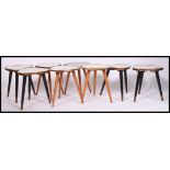 A fabulous set of 8 retro 1950's tripod tables.