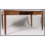 A mid century golden oak Air Ministry military desk raised on tapered legs with drawers to the