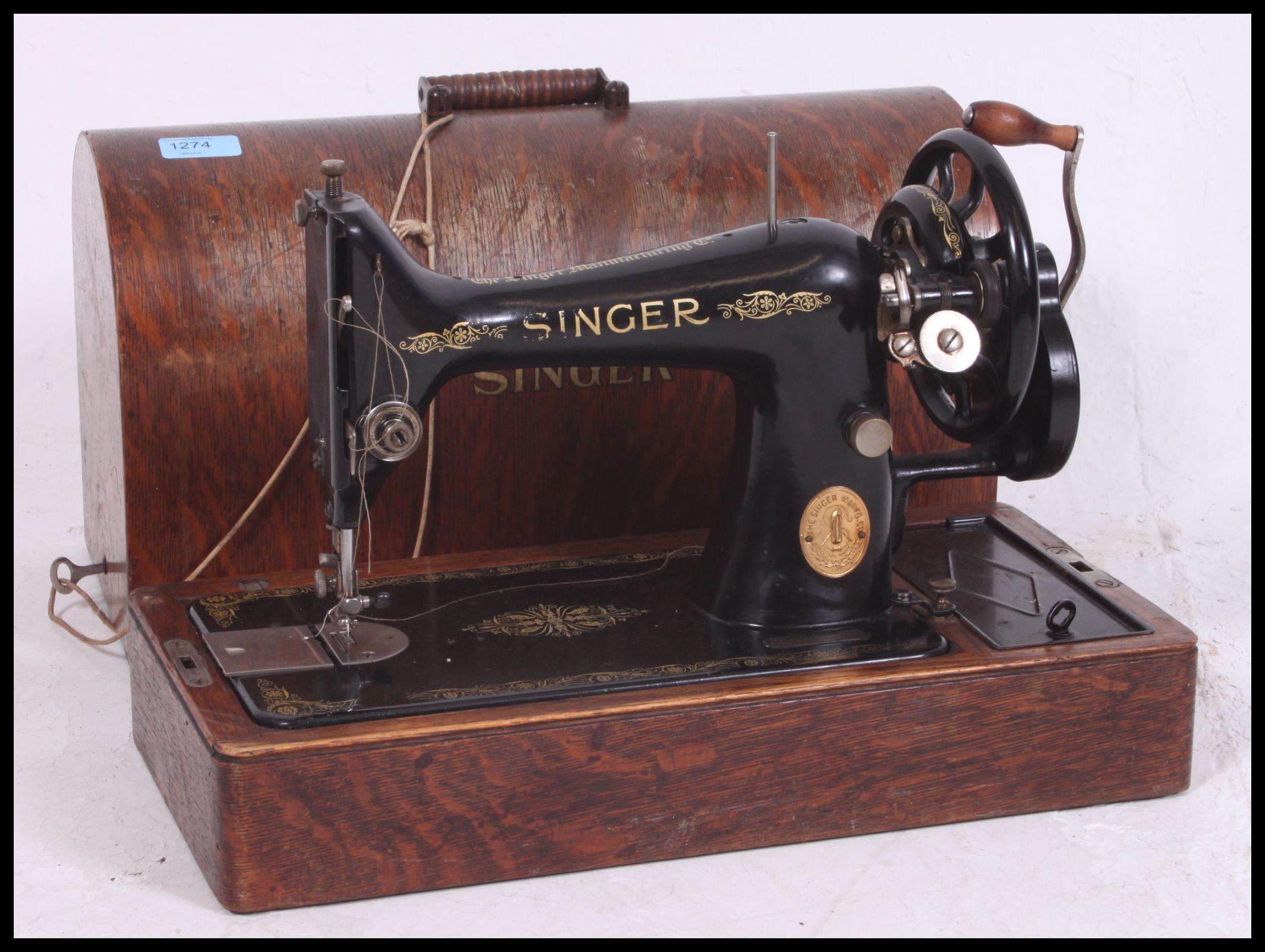 A vintage cased early 20th century Singer sewing machine with manual and accessories complete with