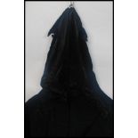 An retro full length 1970's black velvet cloak,