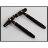 A vintage Swan Mabie Todd Ltd self filler  fountain pen with 14ct gold nib in black with gold trim