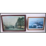 A framed and glazed print of a Lancaster Bomber in flight together with a street scene print of