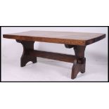 A 20th century rustic oak coffee - occasional  table together with a Mr Chippy oak telephone table