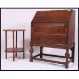 A 1930's Solid oak bureau having a fully appointed interior with drop down front above three