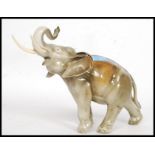 A Royal Dux china figurine of an elephant, with tusks.