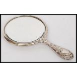 A silver hallmarked hand mirror in repousse stamped for Birmingham 1911 by Henry Matthews.