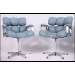 A pair of retro 1970's chrome and blue vinyl upholstered offie swivel chairs.