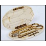 A 19th century ivory cased sewing set, the ivory case of lozenge form being, monogrammed to the lid.