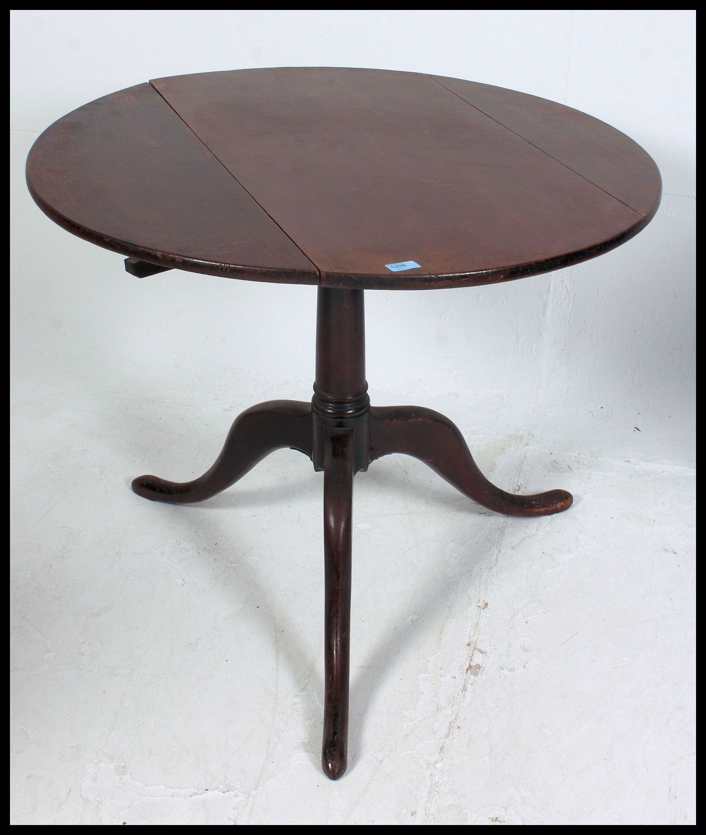 A 19th century Georgian mahogany tilt top dining table being converted one side to drop leaf. - Image 2 of 4