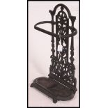 A Victorian Coalbrookdale style cast iron umbrella stand with tray being ebonised.