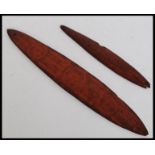 An Aboriginal bullroarer, the flat side incised circles, the domed reverse with linear  circles,