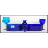 A collection of blue glass items to include handmade examples and Bristol Blue