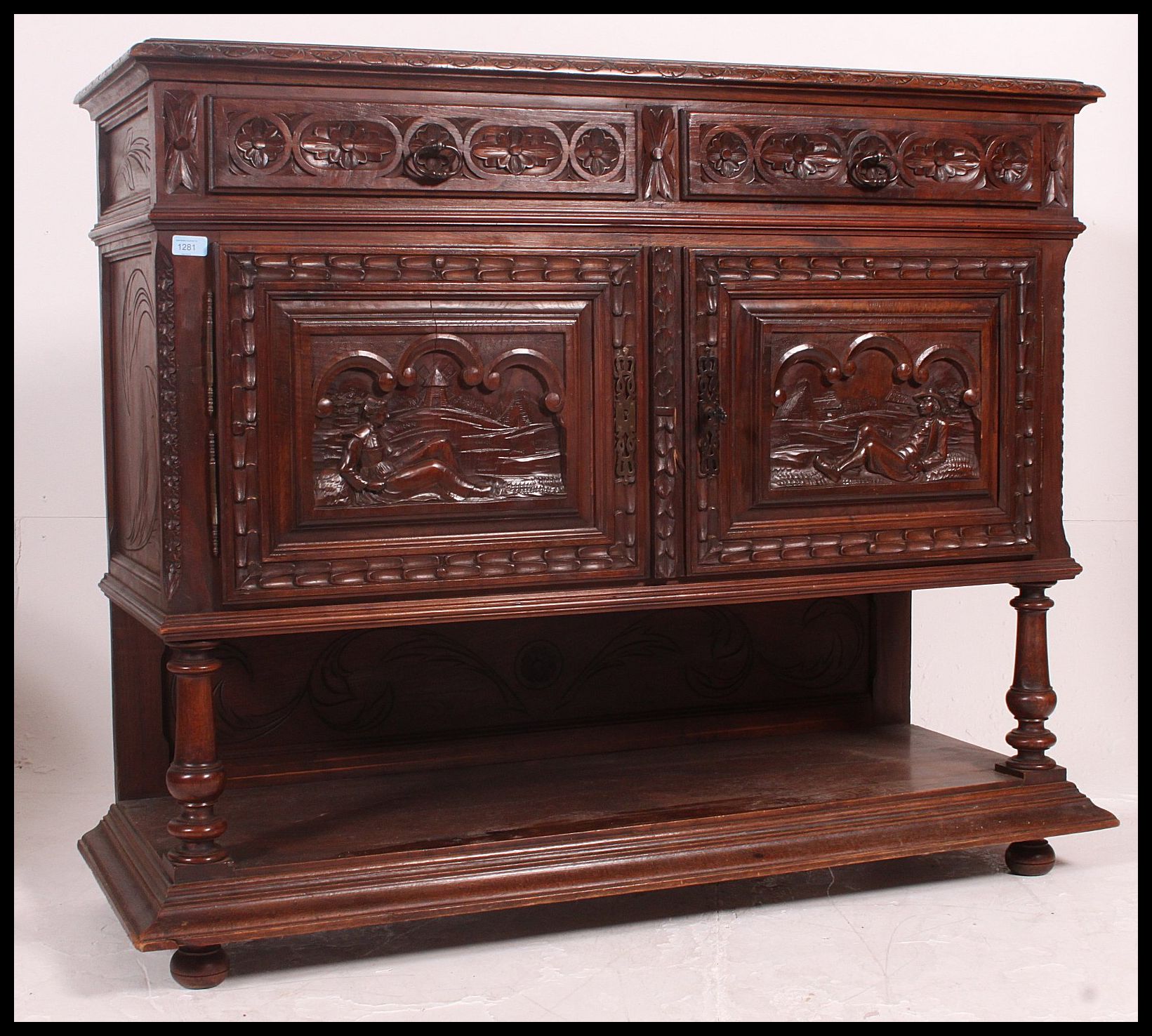 A 19th century Jacobean carved oak green man revival marble top sideboard / buffet.