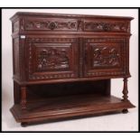 A 19th century Jacobean carved oak green man revival marble top sideboard / buffet.