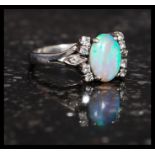 An 18ct gold, opal and diamond ladies ring.