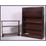 A 1940's Utility type oak students bureau having fall front over bookcase cabinet beneath.