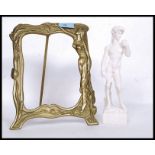 A pair of Parienne style classical figures along with a brass Art Nouveau easel picture frame.