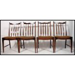 A set of 20th century Stag mahogany dining chairs raised on squared supports with drop in