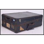 A vintage early 20th century travel trunk, having a hinged lid, travel labels, lined interior,