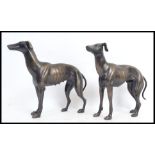 A pair of cast metal bronze effect statues of greyhound racing dogs - each unmarked, no makers name.