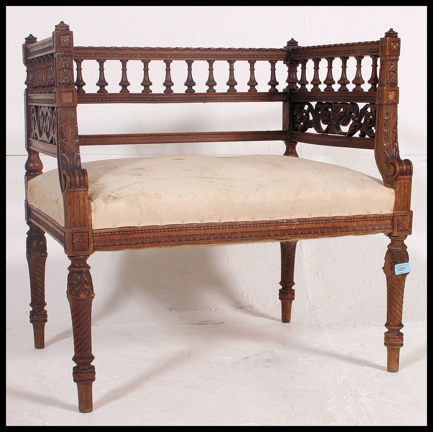 An early 20th century carved walnut Italian window seat.