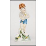 A Royal Worcester porcelain Doughty figure, Young Farmer, of a boy with ducklings, 17.