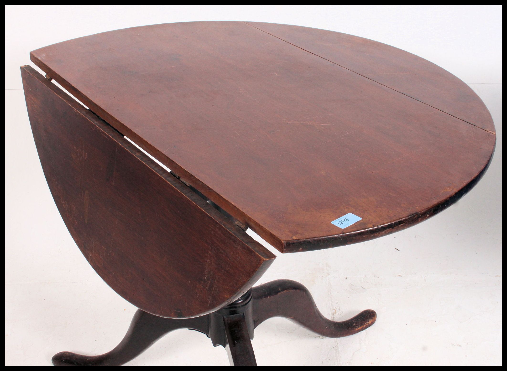 A 19th century Georgian mahogany tilt top dining table being converted one side to drop leaf. - Image 4 of 4