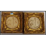 A pair of Parian ware style plaques being mounted in a gilt frame of rococo form.