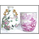 A Chinese famille rose moon flask having peony tree and birds with twin gilded handles.