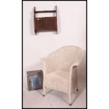 A Lloyd Loom style whicker armchair together with a wall hanging cabinet and another.